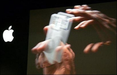 Picture of iPod being passed from one hand to another