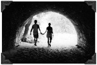 Picture of TJ & Gabe holding hands walking through a tunnel. Photo taken in Zion National Park in Utah, 1999.